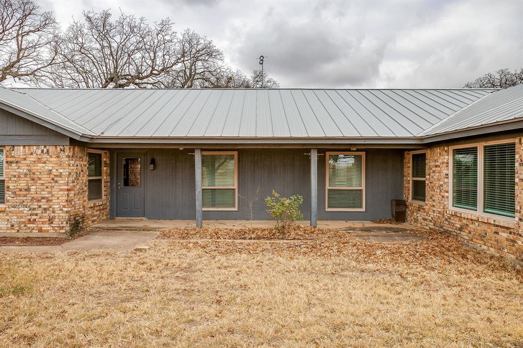938 County Road 3341 Paradise, TX 76073 - Photo 15 of 40 a front view of a house with a patio