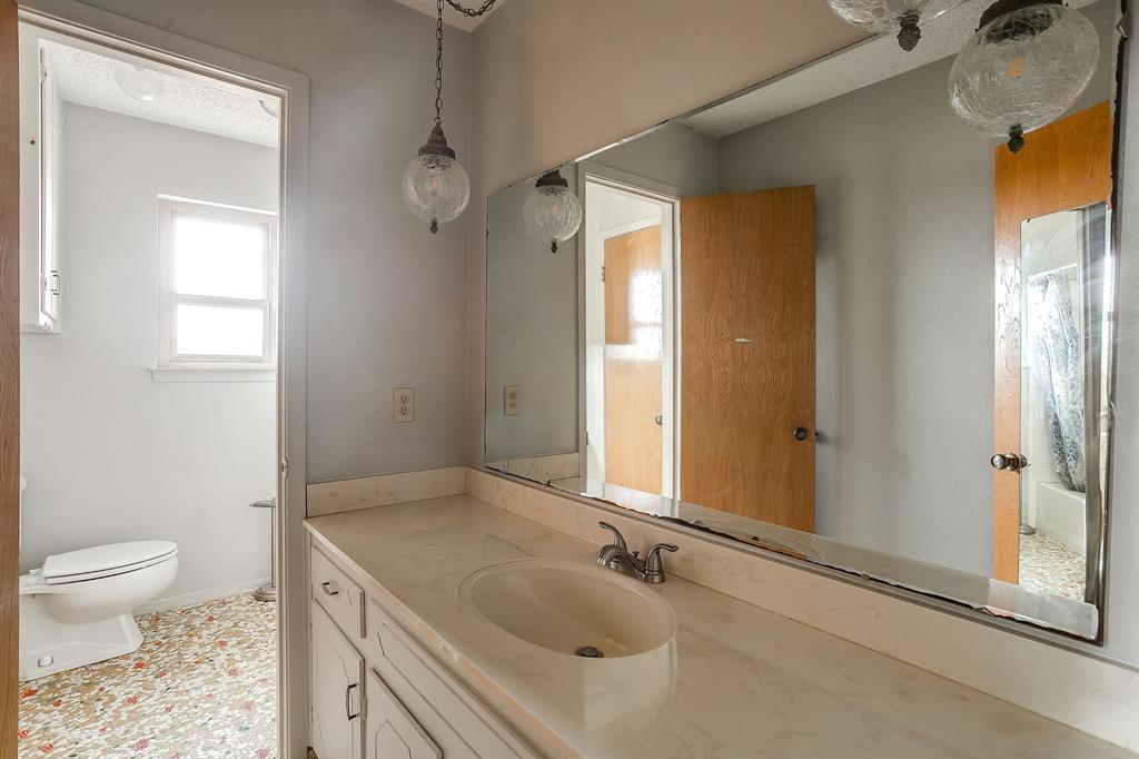 938 County Road 3341 Paradise, TX 76073 - Photo 37 of 40 a bathroom with a sink a toilet and shower