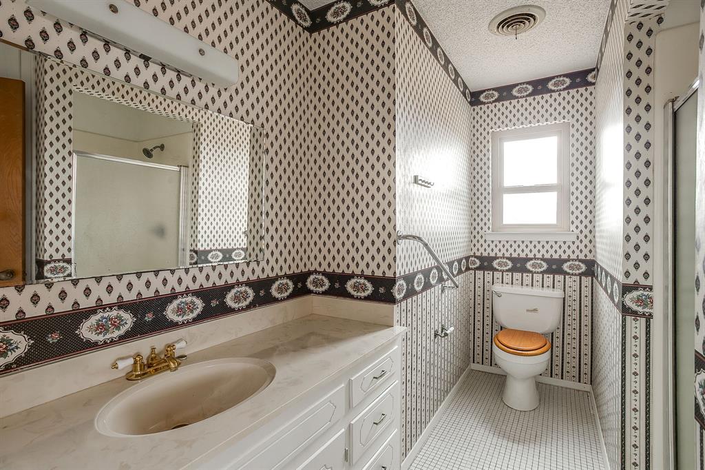 938 County Road 3341 Paradise, TX 76073 - Photo 38 of 40 a bathroom with a sink double vanity and a toilet