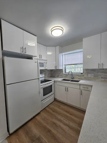 a bathroom with a toilet a sink a mirror and vanity