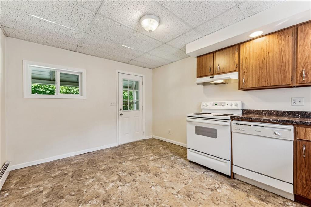 1746 Soap Hollow Road Johnstown, PA 15905 - Photo 12 of 30 a kitchen with stainless steel appliances granite countertop a stove a sink and a microwave