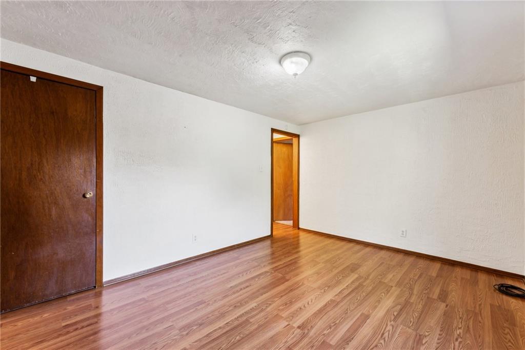 1746 Soap Hollow Road Johnstown, PA 15905 - Photo 20 of 30 a view of an empty room with wooden floor and a window