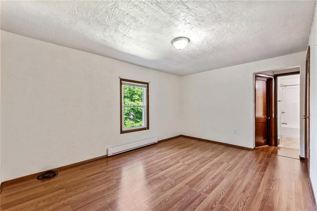 1746 Soap Hollow Road Johnstown, PA 15905 - Photo 21 of 30 an empty room with wooden floor and windows
