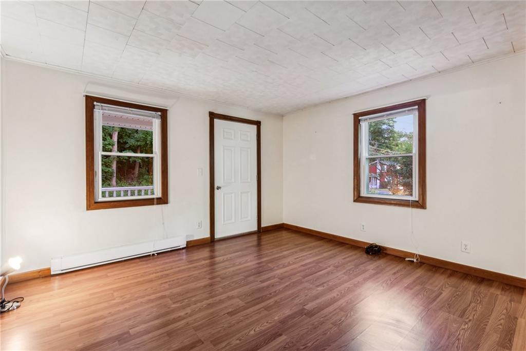 1746 Soap Hollow Road Johnstown, PA 15905 - Photo 7 of 30 a view of an empty room with window and wooden floor