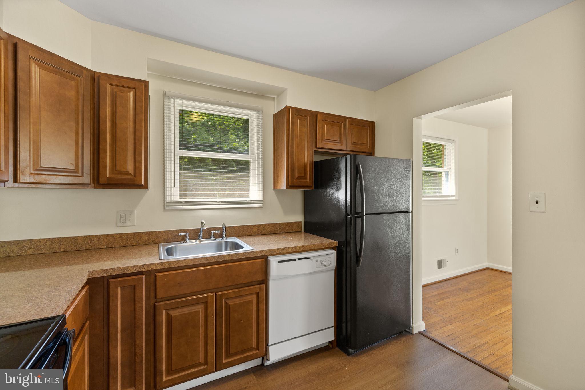 5508 Spruce Drive Clinton, MD 20735 - Photo 11 of 31 a kitchen with stainless steel appliances granite countertop a refrigerator and a sink