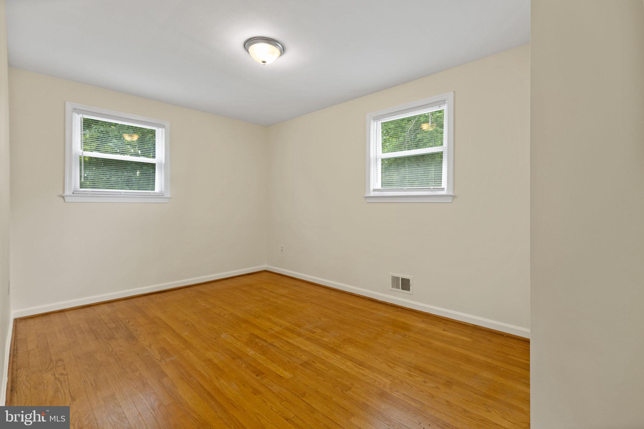 5508 Spruce Drive Clinton, MD 20735 - Photo 16 of 31 a view of an empty room with wooden floor and a window