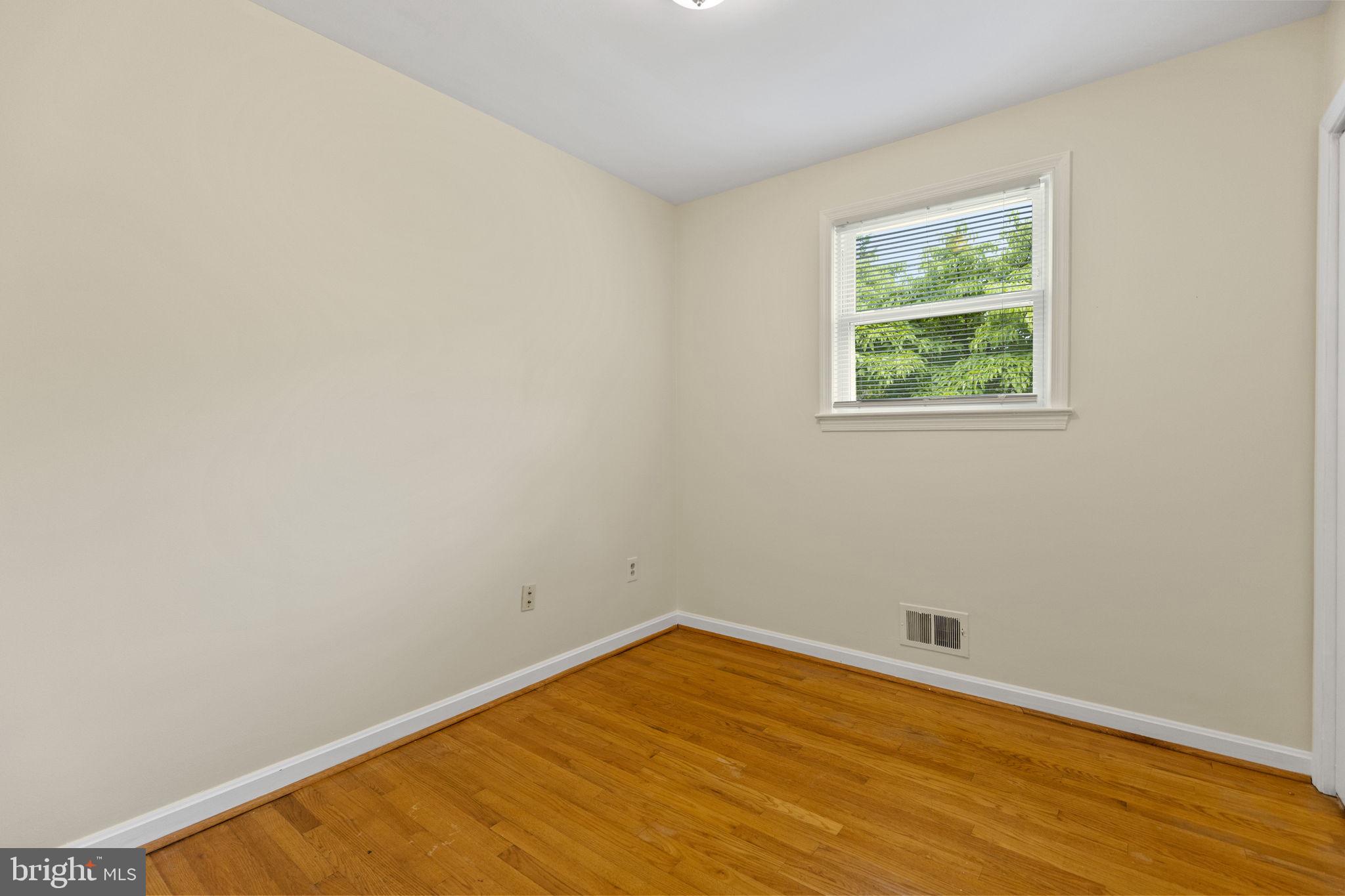 5508 Spruce Drive Clinton, MD 20735 - Photo 18 of 31 an empty room with wooden floor and windows