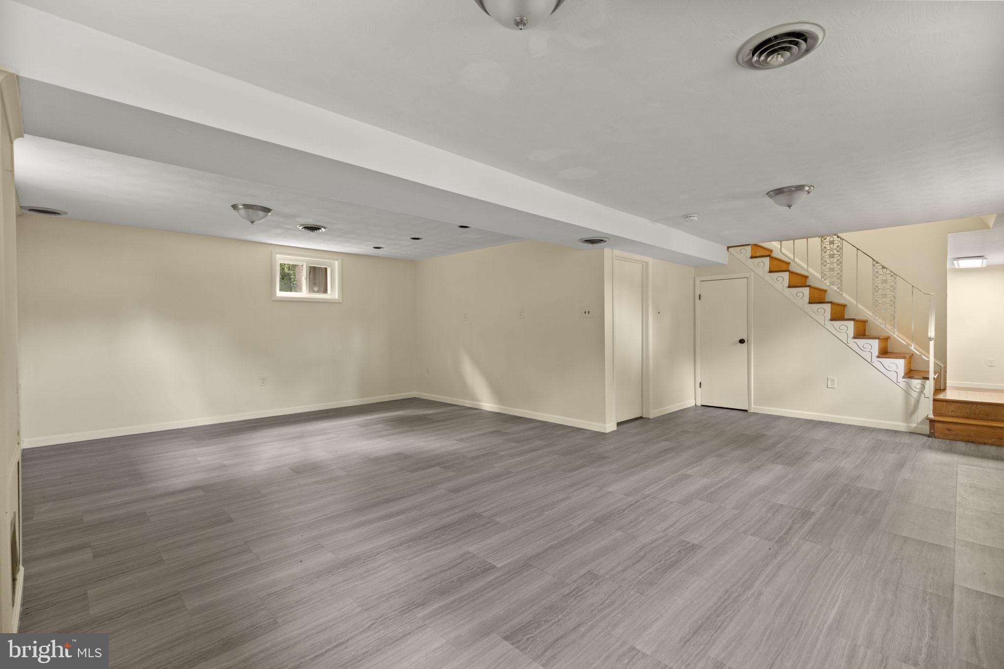 5508 Spruce Drive Clinton, MD 20735 - Photo 21 of 31 an empty room with wooden floor and windows