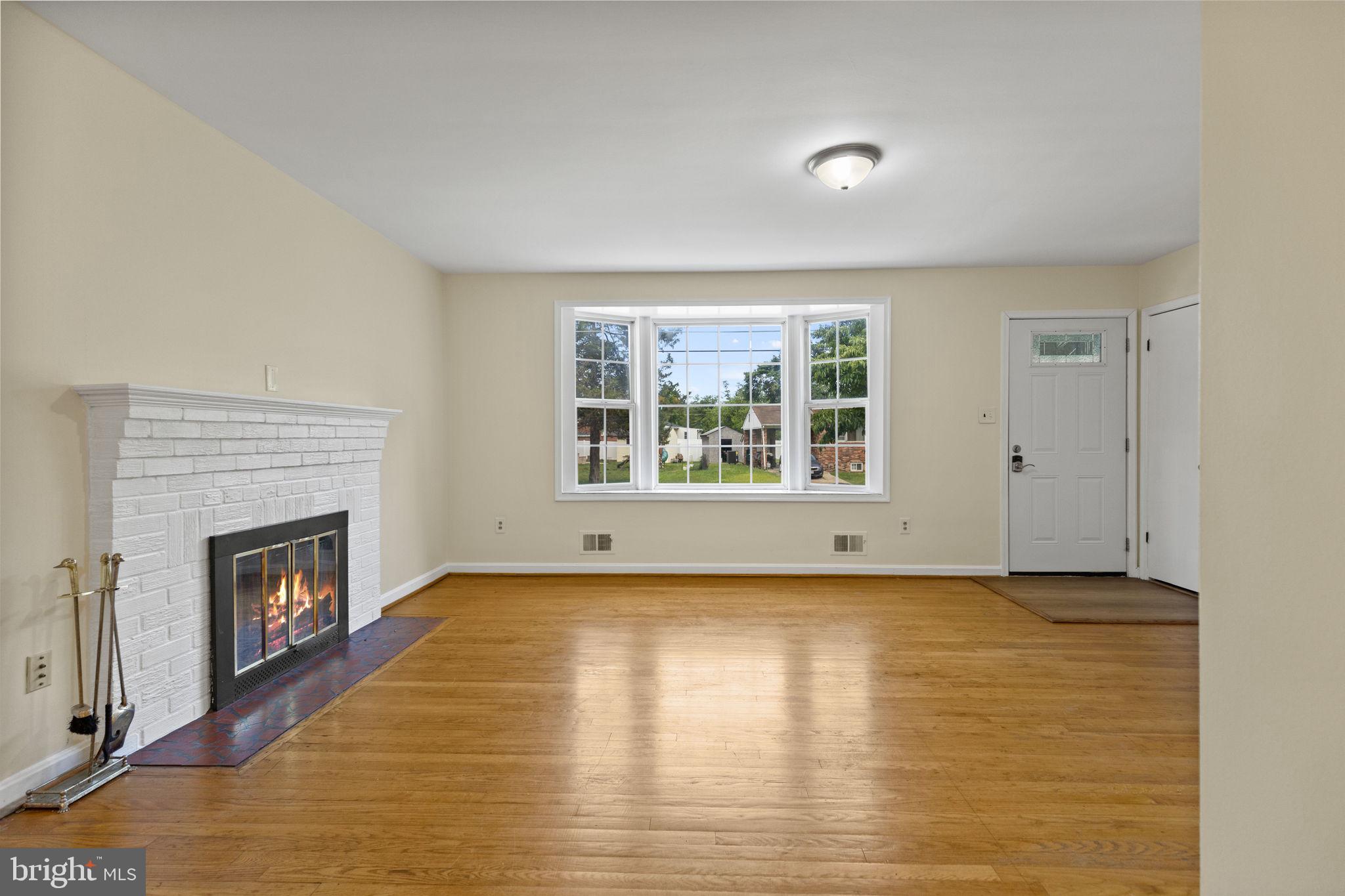 5508 Spruce Drive Clinton, MD 20735 - Photo 6 of 31 an empty room with windows and fireplace