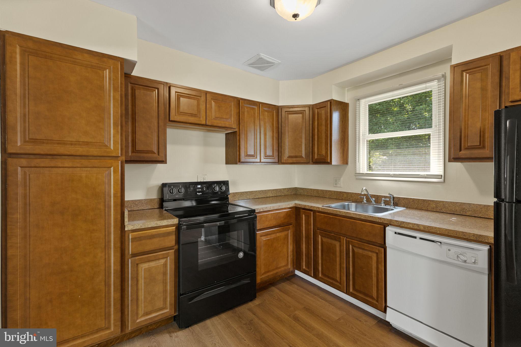 5508 Spruce Drive Clinton, MD 20735 - Photo 8 of 31 a kitchen with a sink stove and refrigerator