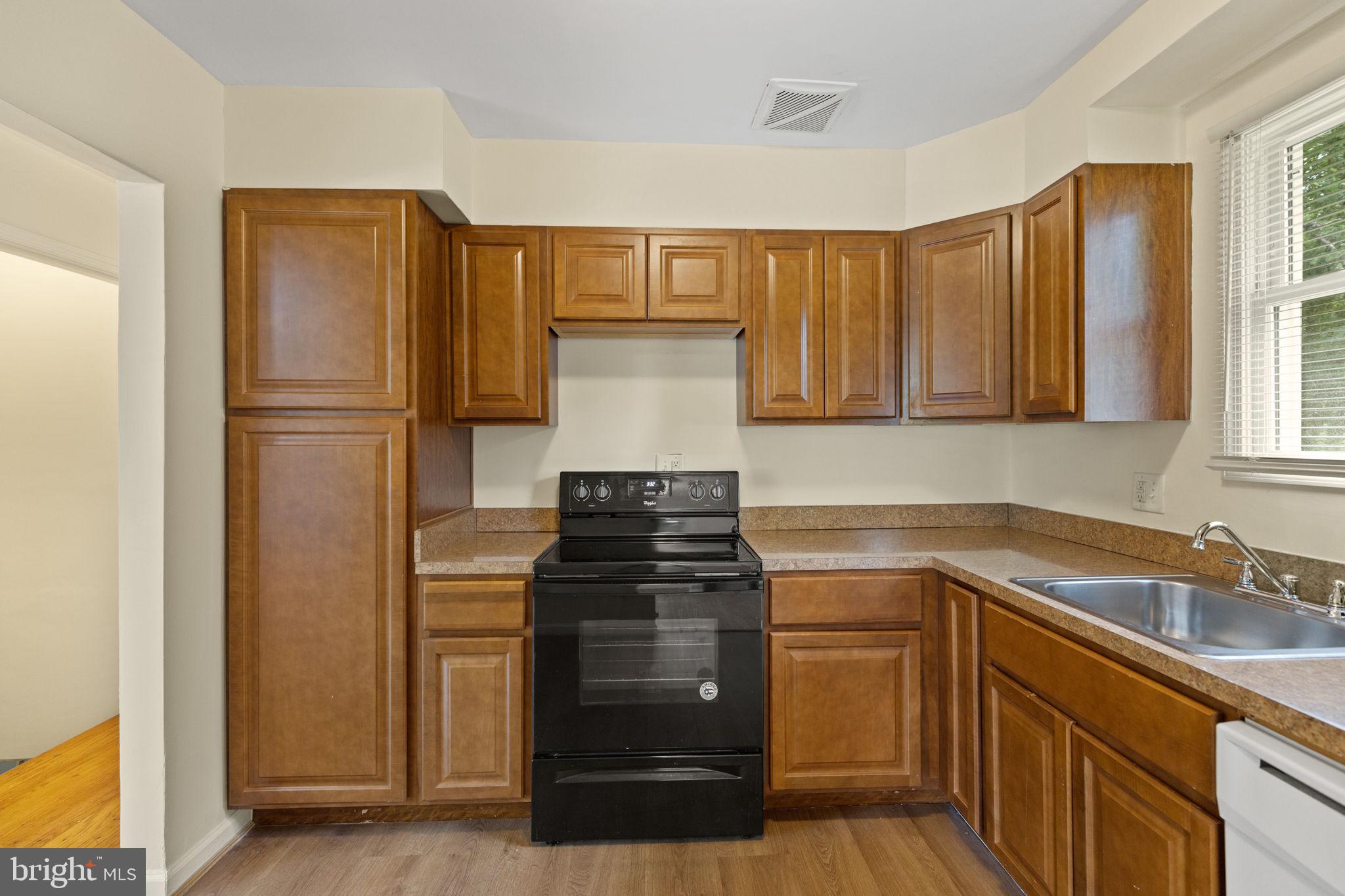 5508 Spruce Drive Clinton, MD 20735 - Photo 10 of 31 a kitchen with a refrigerator and a sink