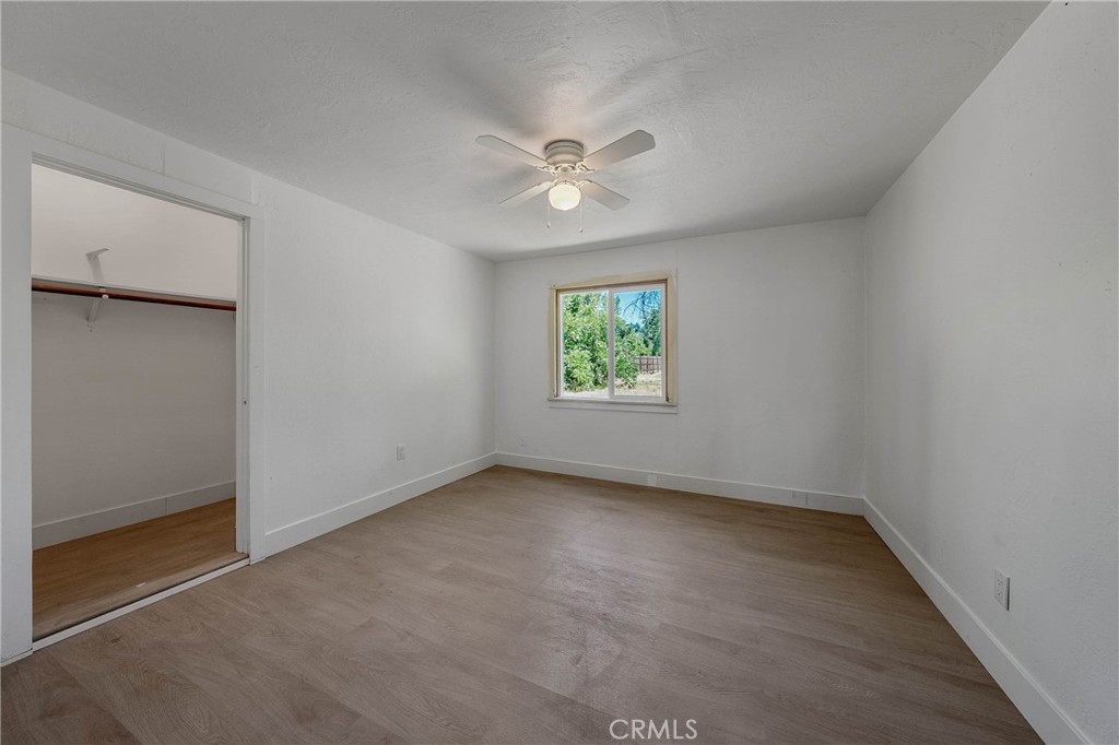 1980 Big Valley Road Lakeport, CA 95453 - Photo 12 of 56 an empty room with a window and a ceiling fan