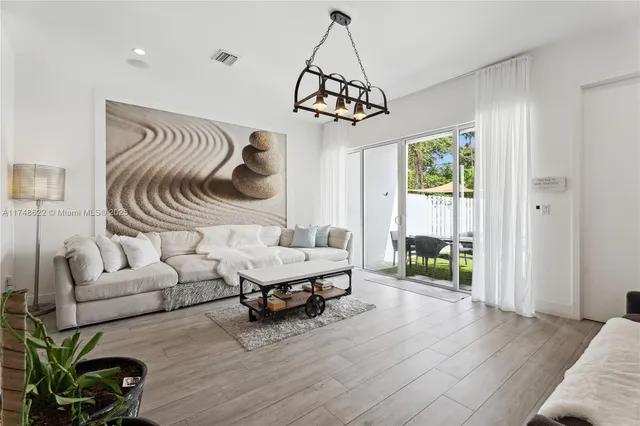 a bedroom with furniture and a wooden floor