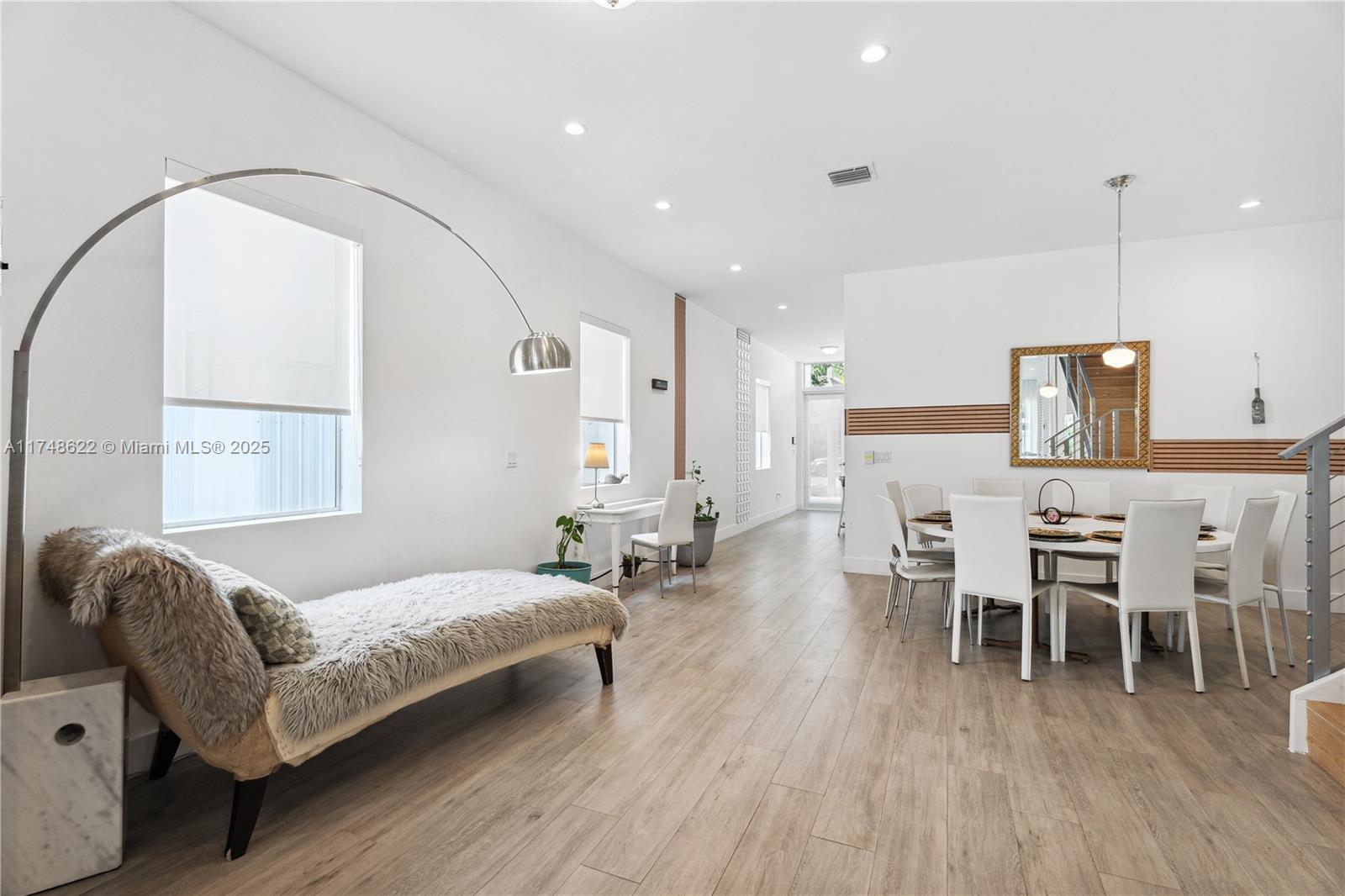 3572 Southwest 23rd Street, Unit 3572 Miami, FL 33145 - Photo 11 of 36 a spacious bedroom with a bed chairs and wooden floor