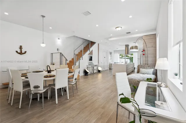 a view of a dining room with furniture wooden floor and chandelier