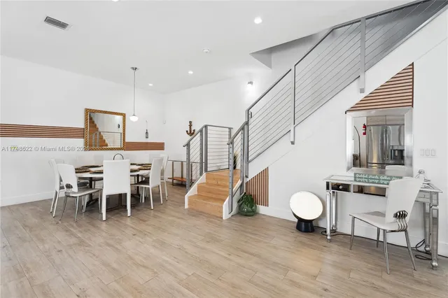 a view of a dining room with furniture wooden floor and chandelier
