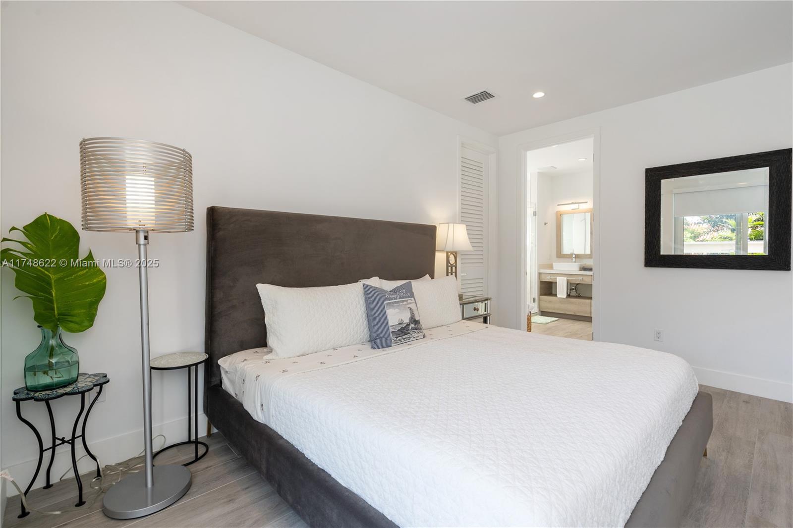 3572 Southwest 23rd Street, Unit 3572 Miami, FL 33145 - Photo 34 of 36 a bedroom with a bed and wooden floor