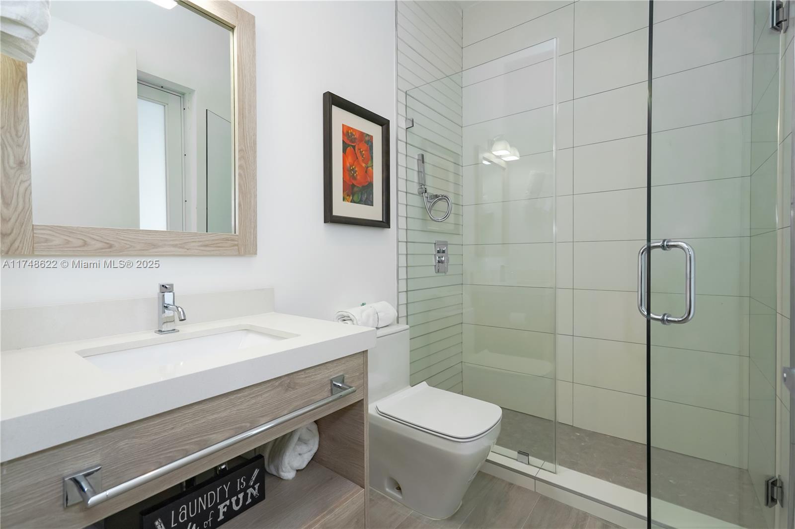 3572 Southwest 23rd Street, Unit 3572 Miami, FL 33145 - Photo 35 of 36 a bathroom with a sink a toilet and shower