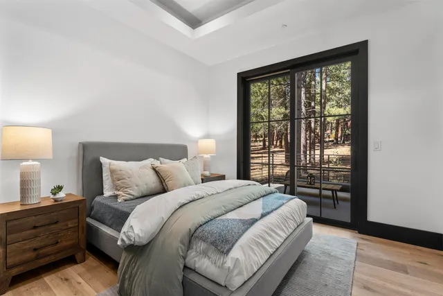 a large bed sitting in a bedroom next to a window