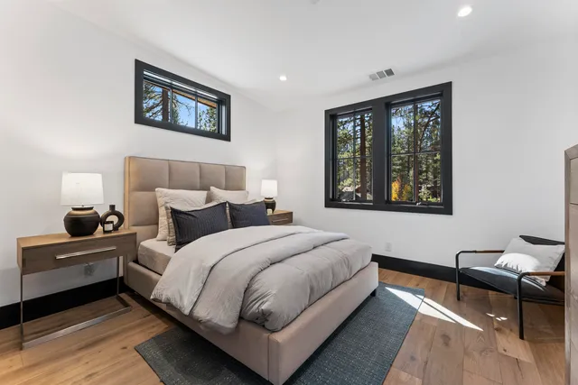 a bedroom with a bed and wooden floor