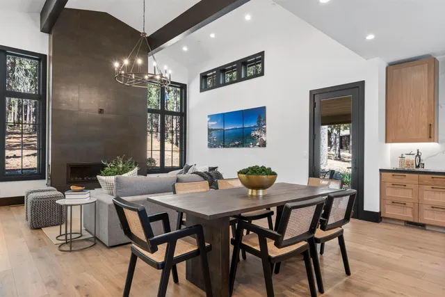 a view of a dining room with furniture and chandelier