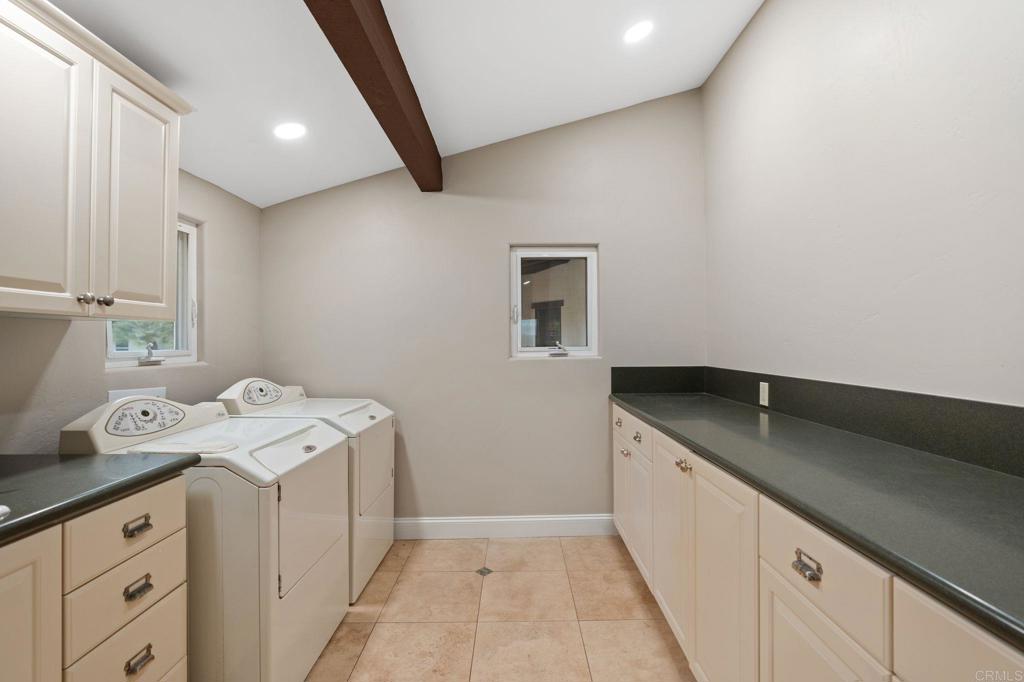 10845 Mystery Mountain Road Valley Center, CA 92082 - Photo 28 of 72 a utility room with a sink a washer and dryer