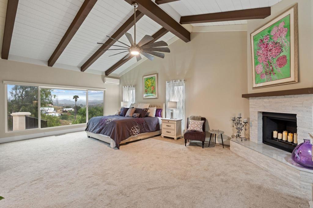 10845 Mystery Mountain Road Valley Center, CA 92082 - Photo 29 of 72 a spacious bedroom with a large bed and a large window