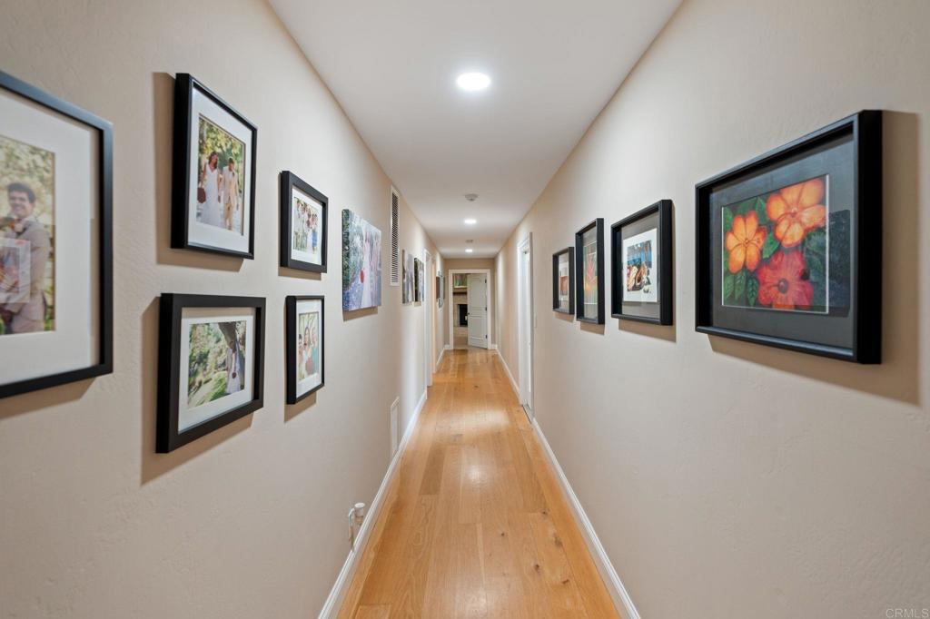 10845 Mystery Mountain Road Valley Center, CA 92082 - Photo 35 of 72 a view of a hallway with paintings on the wall