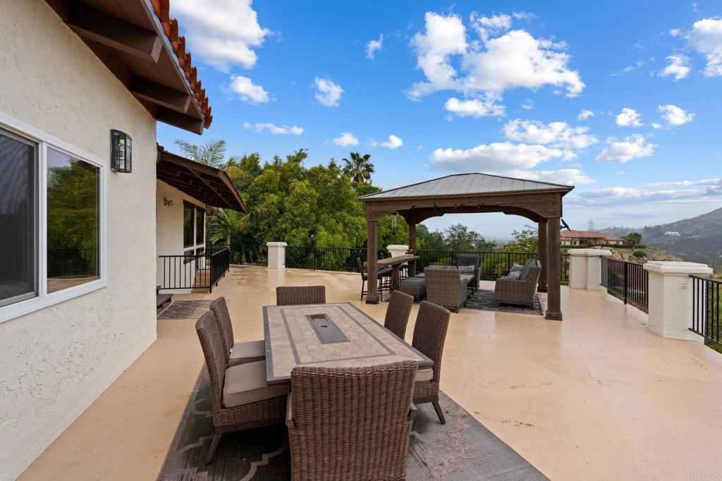 10845 Mystery Mountain Road Valley Center, CA 92082 - Photo 51 of 72 a view of a patio with table and chairs with a barbeque grill and plants