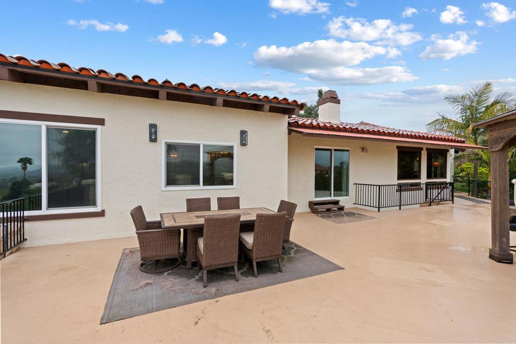 10845 Mystery Mountain Road Valley Center, CA 92082 - Photo 52 of 72 a roof deck with table and chairs and potted plants with sky view