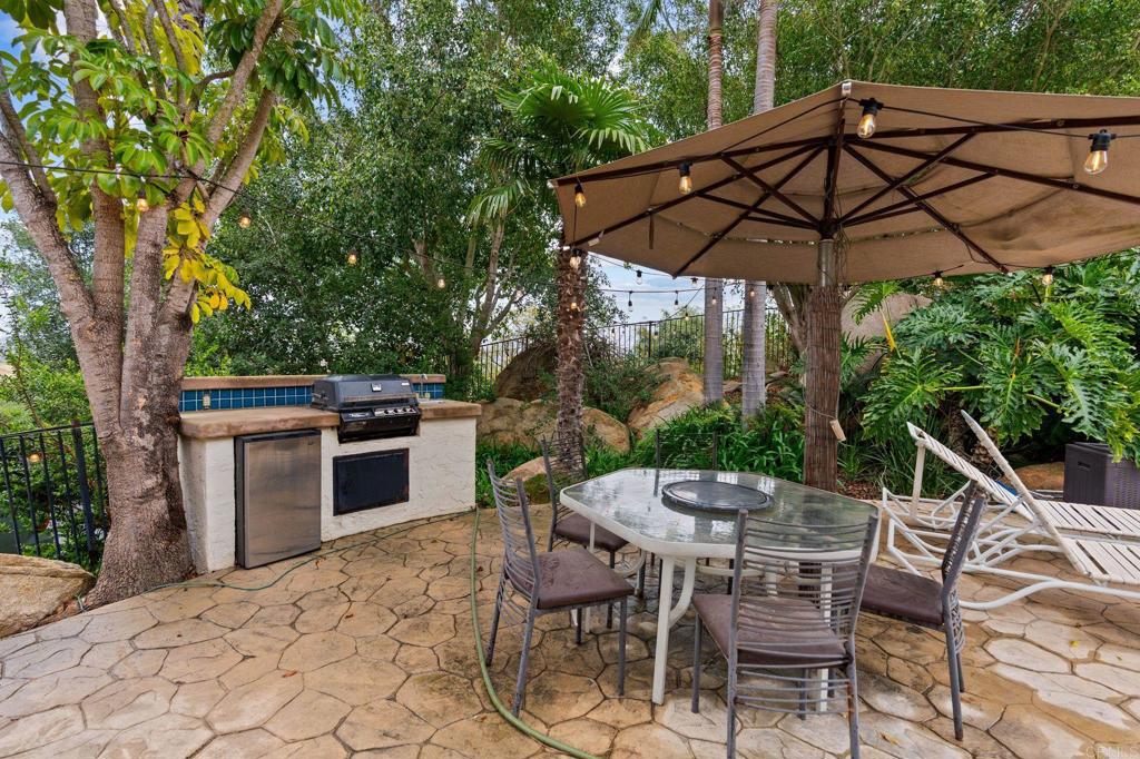 10845 Mystery Mountain Road Valley Center, CA 92082 - Photo 56 of 72 a patio with a patio table and chairs