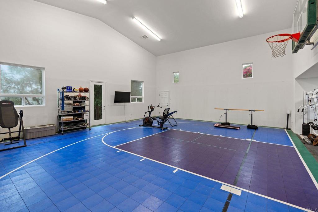 10845 Mystery Mountain Road Valley Center, CA 92082 - Photo 8 of 72 a room with gym equipment and a flat screen tv