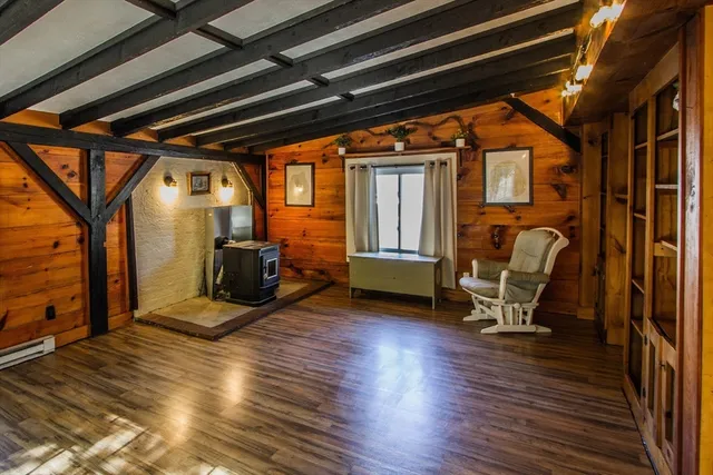 a view of a room with wooden floor and furniture