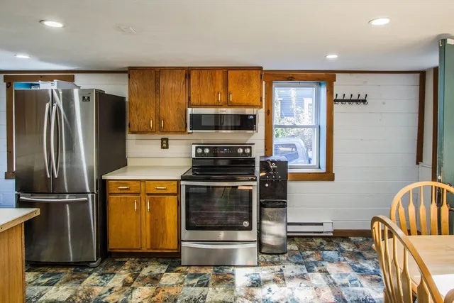 a kitchen with stainless steel appliances granite countertop a refrigerator stove and sink