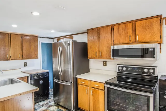 a kitchen with a refrigerator stove and microwave