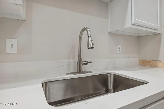 a kitchen with a sink and granite