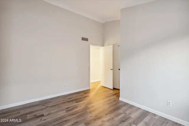 a view of an empty room with wooden floor
