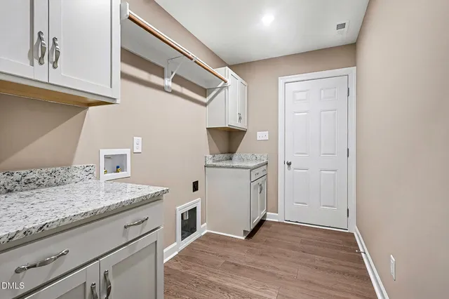 a bathroom with bathtub and a window