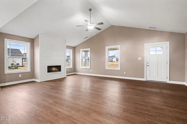 a bathroom with a granite countertop sink and a toilet
