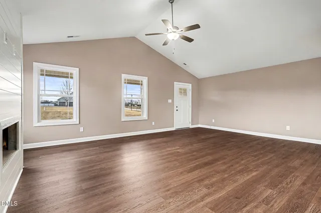 an empty room with windows and closet