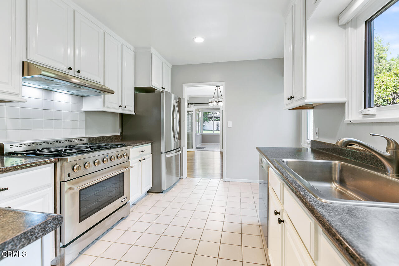 1195 Afton Street Pasadena, CA 91103 - Photo 12 of 36 a kitchen with granite countertop a sink stainless steel appliances and cabinets