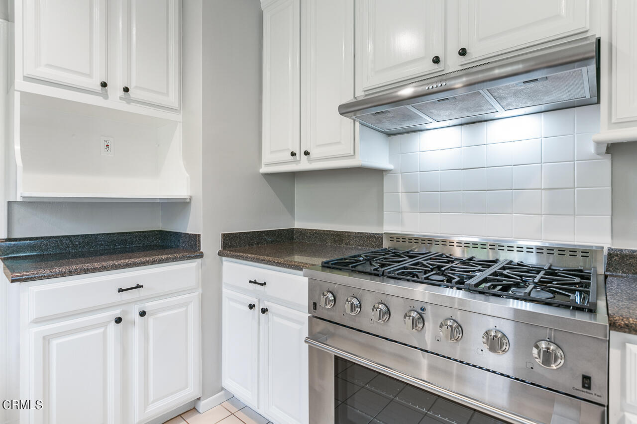 1195 Afton Street Pasadena, CA 91103 - Photo 13 of 36 a white stove top oven sitting inside of a kitchen