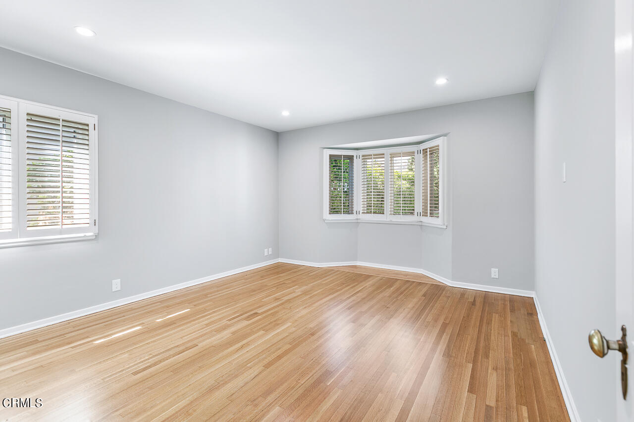1195 Afton Street Pasadena, CA 91103 - Photo 16 of 36 a view of an empty room with wooden floor and a window