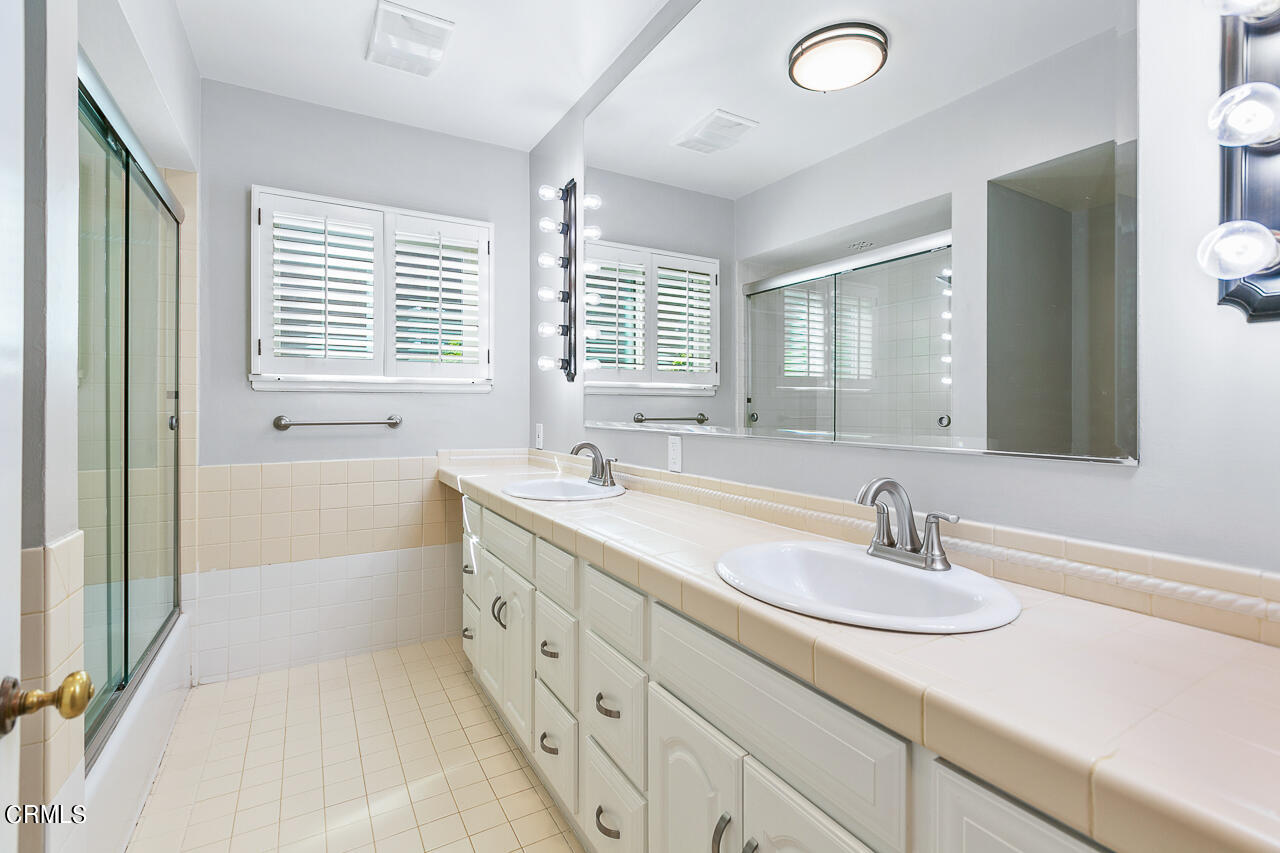 1195 Afton Street Pasadena, CA 91103 - Photo 18 of 36 a bathroom with double vanity sink a mirror and a bathtub