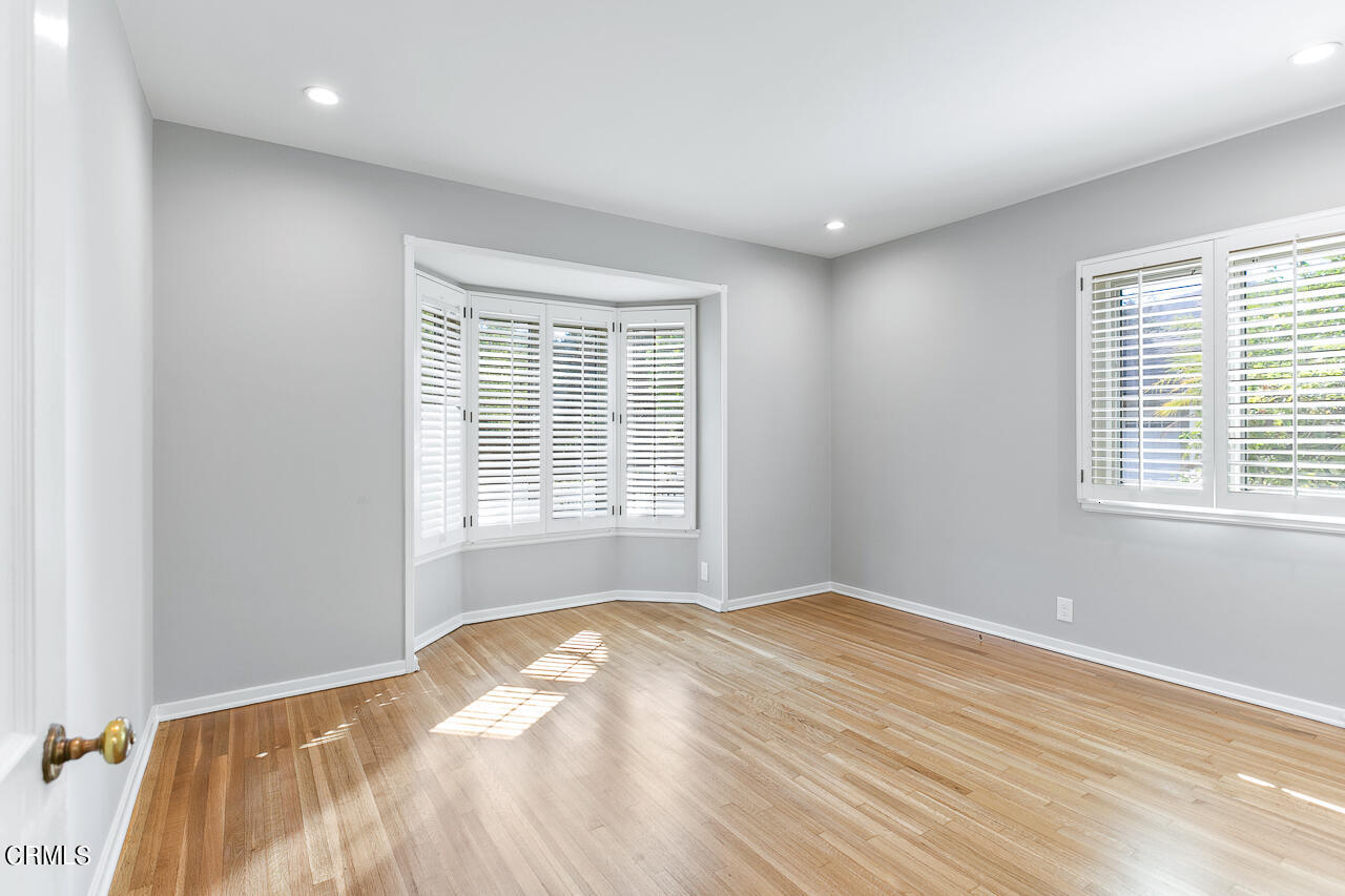 1195 Afton Street Pasadena, CA 91103 - Photo 19 of 36 a view of a bedroom with a bed and a window