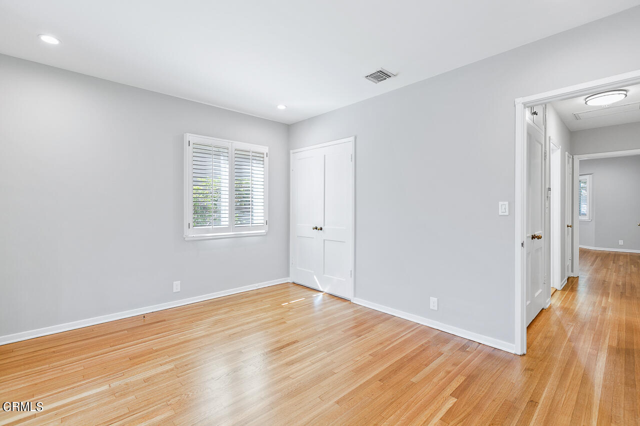 1195 Afton Street Pasadena, CA 91103 - Photo 20 of 36 a view of an empty room with wooden floor and a window