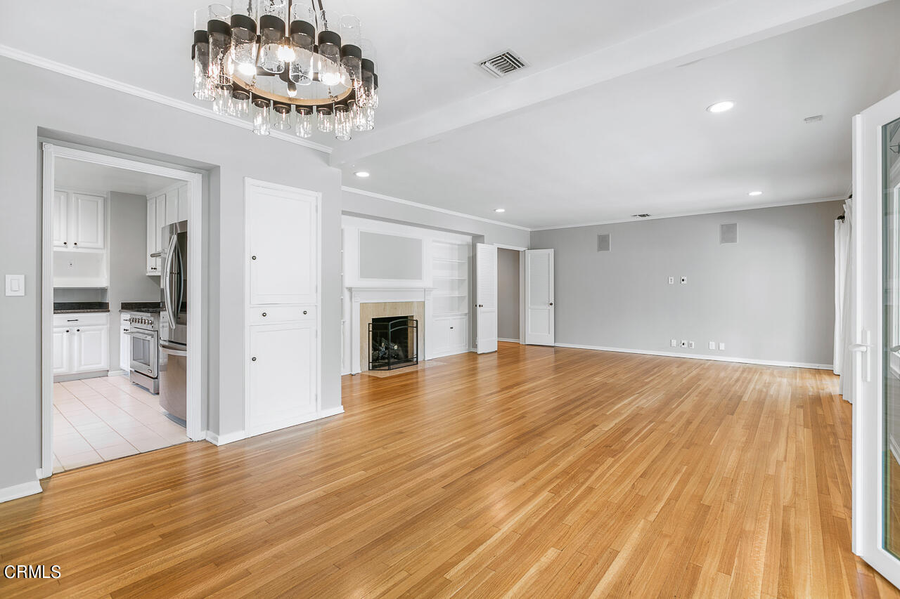 1195 Afton Street Pasadena, CA 91103 - Photo 8 of 36 a view of empty room with wooden floor and kitchen view