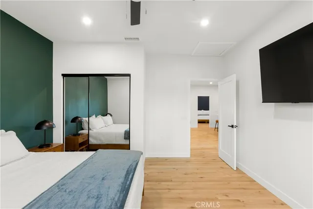 a bedroom with a bed and flat screen tv