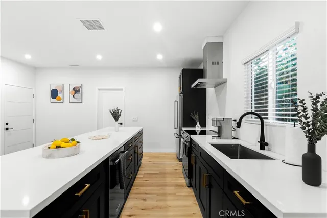 a kitchen with a sink a stove and cabinets