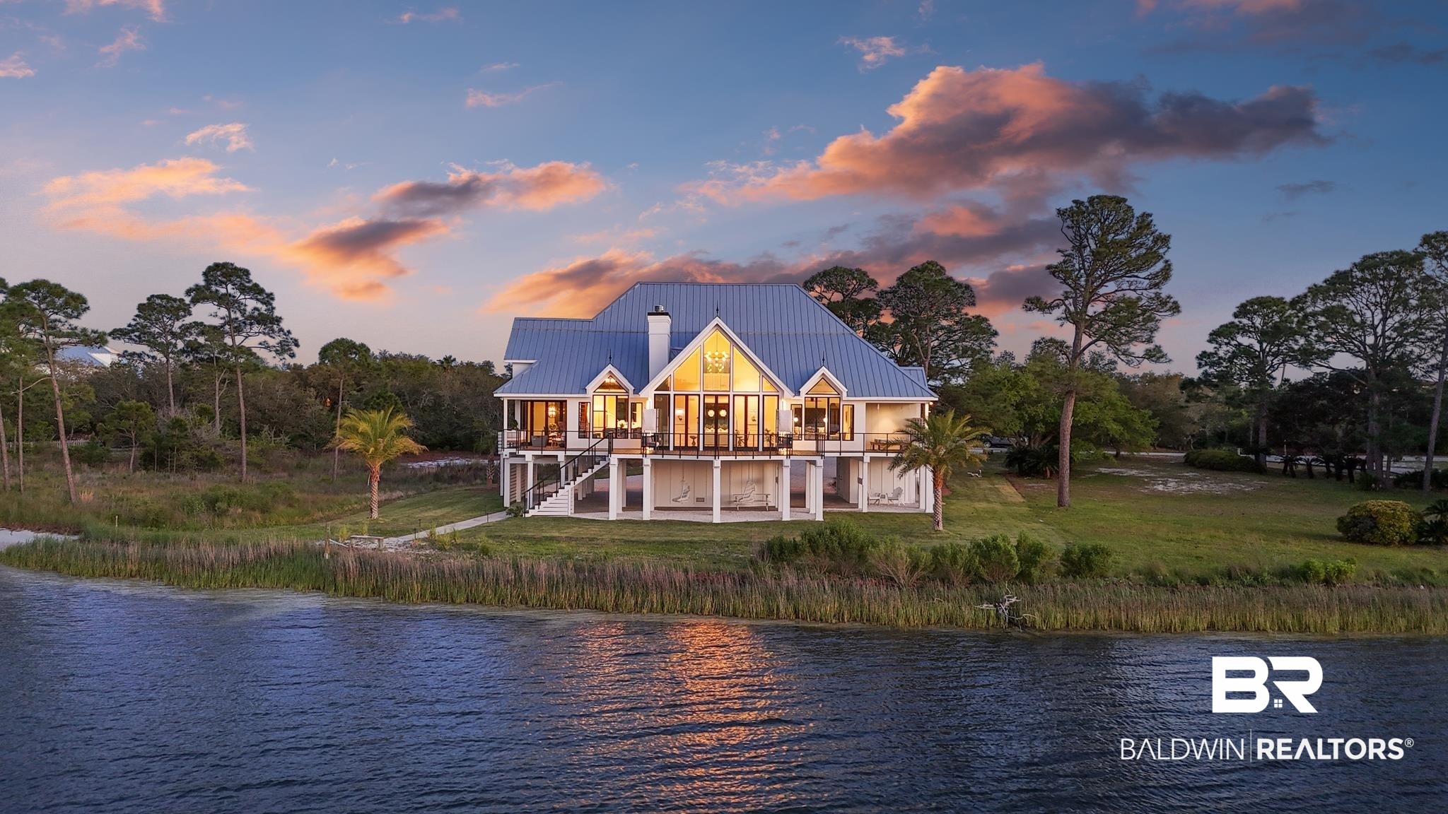 33349 River Road Orange Beach, AL 36561 - Photo 53 of 61 Waterfront residence featuring a metal roof, prominent gables, elevated architecture, multiple balconies, and abundant windows